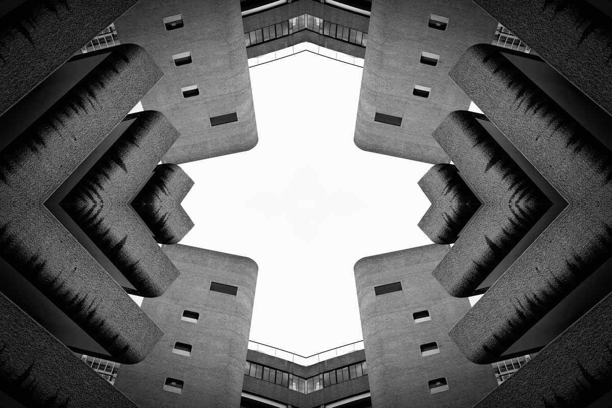 Looking up at the Barbican Centre — deep concrete masses framing an opening of sky