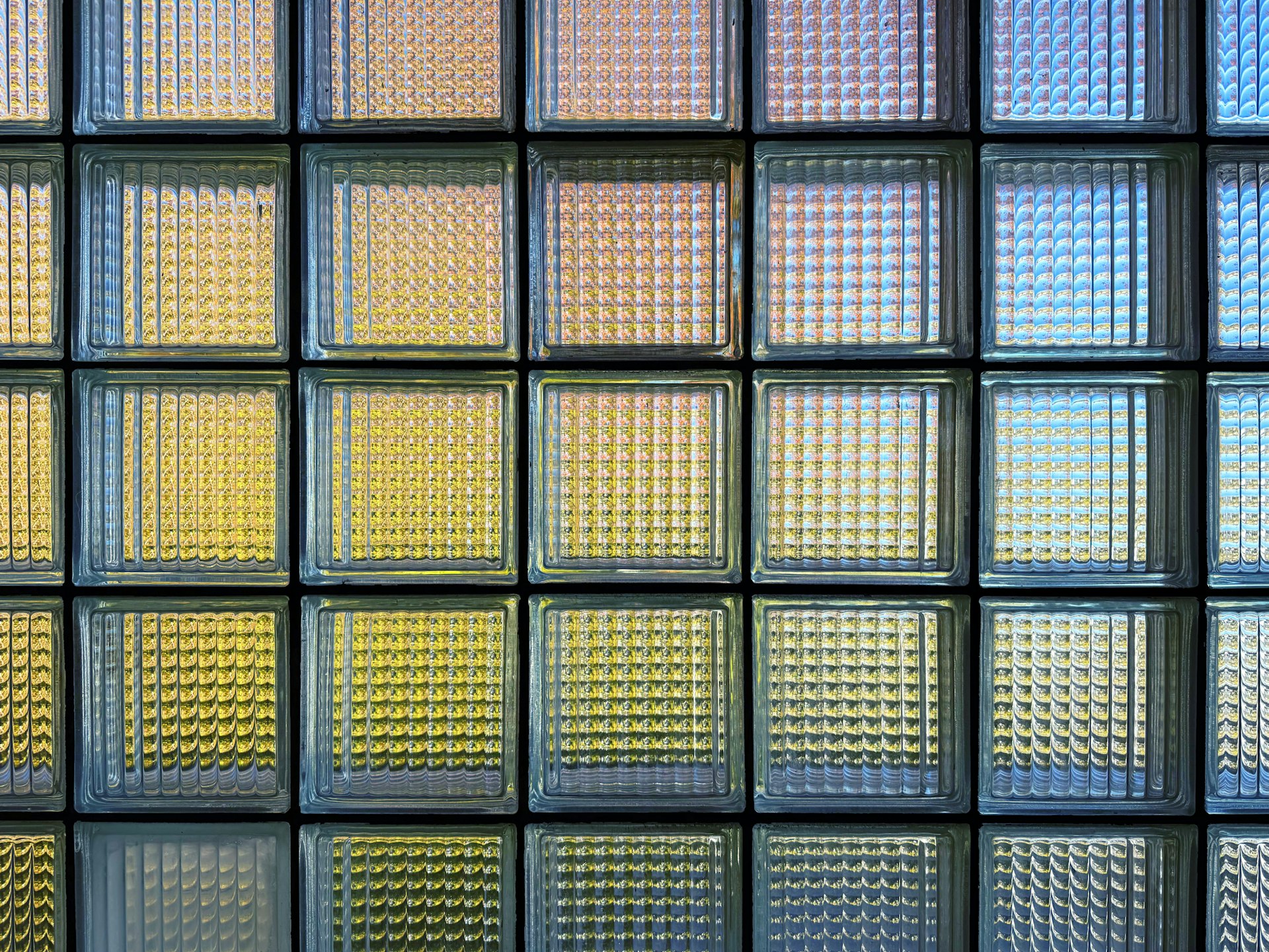 Interior glass block wall diffusing afternoon light into a soft, sourceless glow