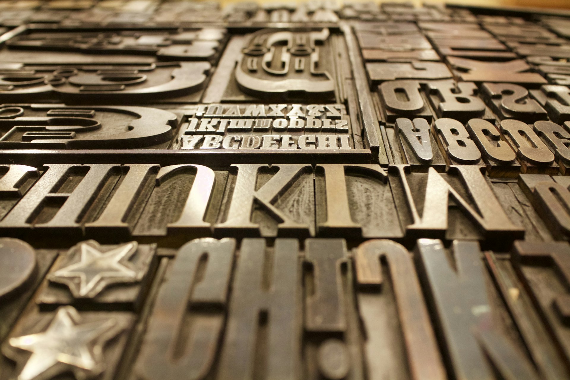 Letterpress type blocks and printing press machinery — the physical act of making posters